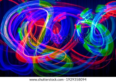 Light painting abstract background. Photography in blue, red, green and yellow light, slow shutter speed,