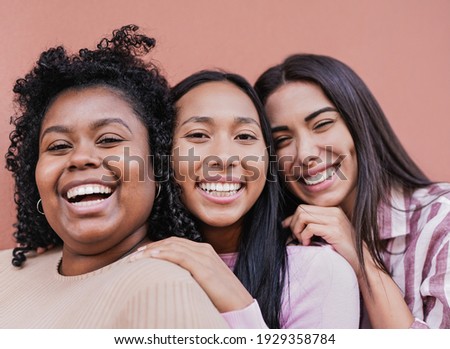Cheerful multiracial women with different skin color looking in camera - Concept of friendship and happiness Royalty-Free Stock Photo #1929358784