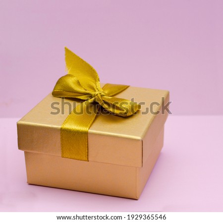 White present with red ribbon on the bright red background . Festive backdrop for holidays: Birthday, Valentines day, Christmas, New Year.