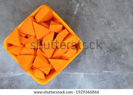 Segmented triangular pumpkins on grey background. sliced
