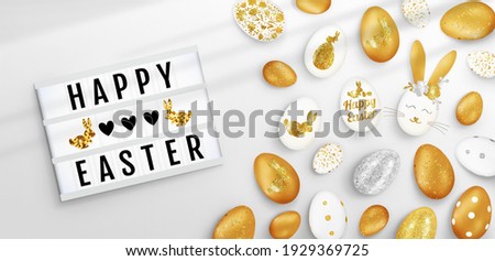 Lightbox, many shining silver, white, golden eggs on a white background. Eggs with flowers, bunnies, hearts, inscription Happy Easter. Easter holiday mockup, big banner. Top view, close up, copy space