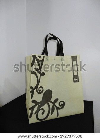 Golden Color Non Woven ECO Shopping bag with black background. site guest view box Bag