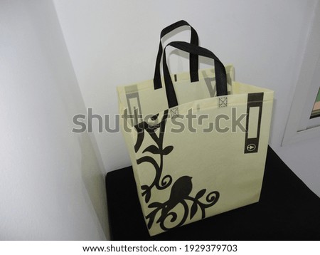 Golden Color Non Woven ECO Shopping bag with black background. site guest view box Bag
