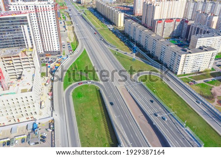 Urban highway car traffic bridge, junction with multistorey buildings, aerial view
