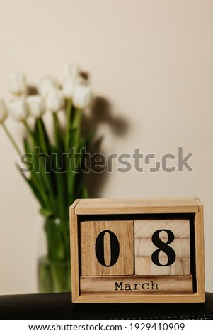Wooden calendar 8 march, bouquet of white fresh tulips. High quality photo