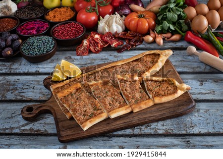 Traditional Turkish food, lahmacun and kiymali and kusbasili pide. Many kinds of traditional food on the rustic table. 