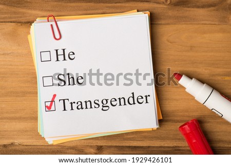 he she or transgender choosing concept. Photo above of notes paperclips and marker isolated on the wooden background