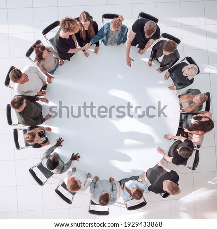 group of diverse young people at a round table meeting