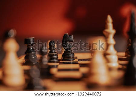 Knight black chess piece on chessboard Royalty-Free Stock Photo #1929440072