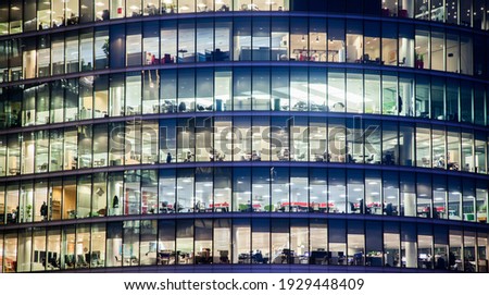 business office windows at night  Corporate building London City  England Royalty-Free Stock Photo #1929448409
