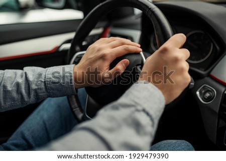 angry driver presses the horn of the car to attract the attention of the car bully and avoid road accident. Stress and aggressive driving on city streets Royalty-Free Stock Photo #1929479390