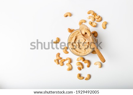 Jar of cashew butter with cashew nuts on the white  background Royalty-Free Stock Photo #1929492005