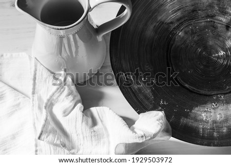 Basin of water, pitcher and white linen, black and white Royalty-Free Stock Photo #1929503972