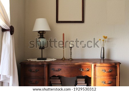 Antique and vintage style wooden desk decor. Empty picture frame, mock up frame