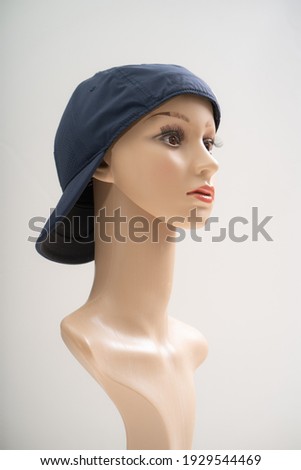 Mannequin wearing a cap in front of the white background