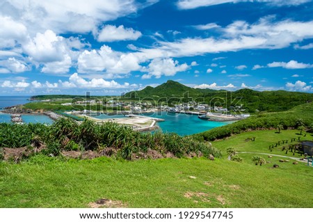 Kubura port with its transparent waters surrounded by green vegetation seeing from the westernmost point of Japan. Yonaguni Island.   Royalty-Free Stock Photo #1929547745