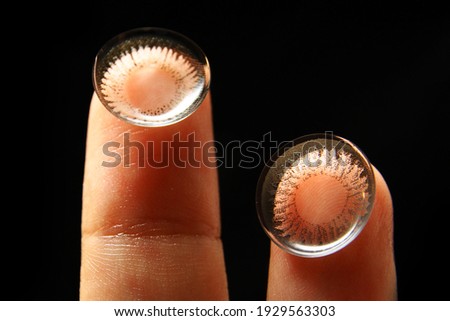 Close up of used contact lenses on finger