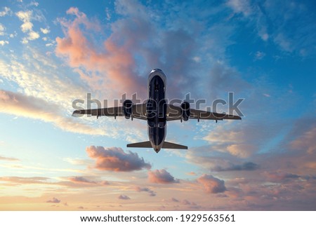 Jet after departing airport at sunset Royalty-Free Stock Photo #1929563561