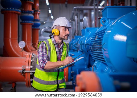 Industry engineer under checking the industry cooling tower air conditioner is water cooling tower air chiller HVAC of large industrial building to control air system. Royalty-Free Stock Photo #1929564059