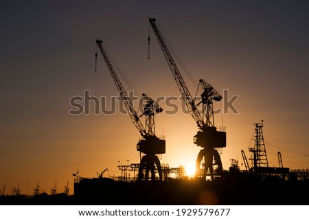 View of two cranes in the port of Mar del Plata at sunset Royalty-Free Stock Photo #1929579677