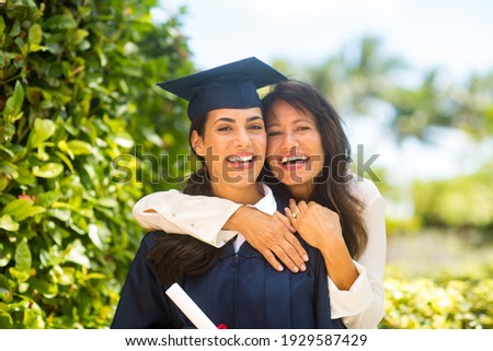 Proud mother hugging her daugher at her graduation Royalty-Free Stock Photo #1929587429