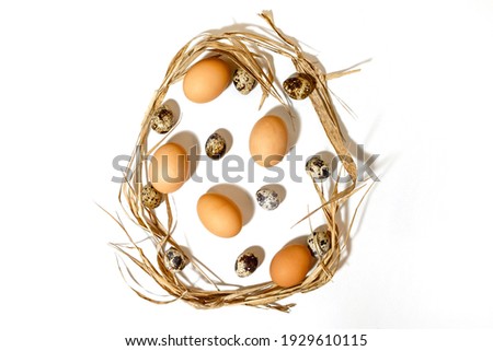 The Easter egg shape is made of eggs and straw. Minimal holiday concept. Flat ley, top view. .