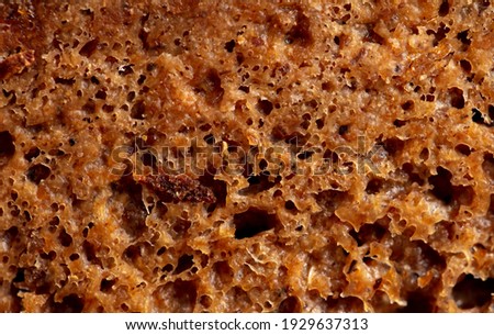 Black rye bread as background. Close-up .