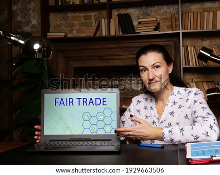  FAIR TRADE text in search bar. Businessman looking for something at cellphone. FAIR TRADE concept. An arrangement designed to help producers in growing countries achieve sustainable
