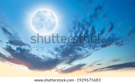 Night sky with moon in the clouds at sunset "Elements of this image furnished by NASA