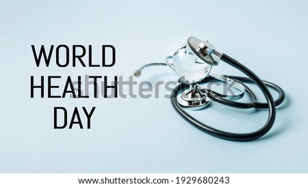 World Health Day, medical and healthcare. Stethoscope and glass global on blue background, copy space.