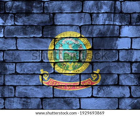 The national flag of the United States of America. On a brick wall with scuffs. Background for design and presentations.
