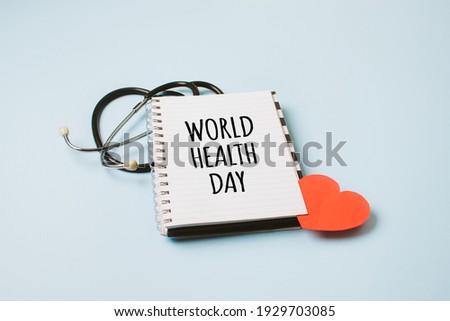 World Health Day, medical and healthcare. Stethoscope and text World Health Day in open notepad on blue background.