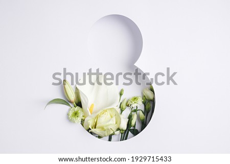 Number 8 with fresh gerbera, calla and rose flowers with green leaves on bright white background. Minimal Women's day, March 8th or birthday concept. Flat lay, top view. Royalty-Free Stock Photo #1929715433