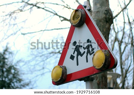 European traffic sign, warning the poximity of an school crosswalk.