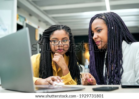 Business professionals. Group of young confident business people analyzing data using computer while spending time in the office. Royalty-Free Stock Photo #1929731801