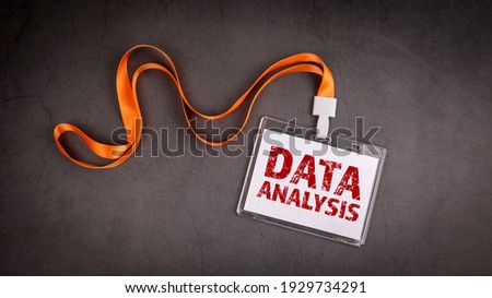 Data Analysis. Name tag, ID card on gray concrete background.