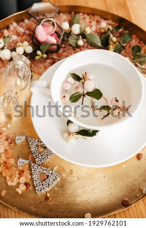 Bride morning details, bridesmaid earrings, engagement ring in a cup of herbal tea