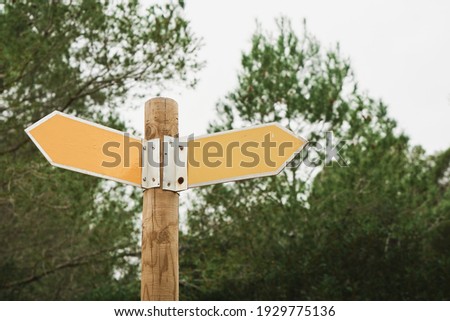 Traffic signs on a road in the forest. Yellow hiking trail signs