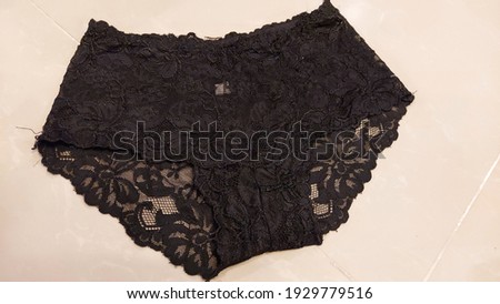 Macro shot of the textures and beautiful patterns of black high-waisted floral lace luxury women panty. 