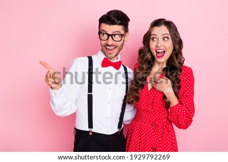 Photo of nice impressed brown hair couple point empty space wear trend cloth isolated on pastel pink color background