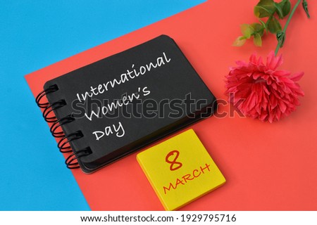Notebook written with text INTERNATIONAL WOMEN'S DAY.