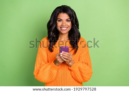 Portrait of attractive content cheerful girl using device media news app 5g isolated over green pastel color background
