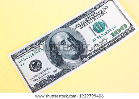 Hundred dollar bill close-up on yellow background. Space for text. Economy, business and financial profit concept. High quality photo