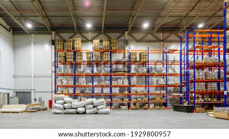 Interior of a modern warehouse storage of retail shop with pallet truck near shelves Royalty-Free Stock Photo #1929800957