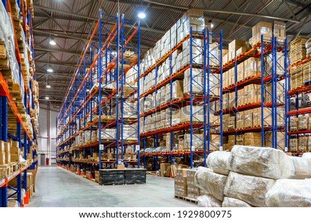 Interior of a modern warehouse storage of retail shop with pallet truck near shelves Royalty-Free Stock Photo #1929800975