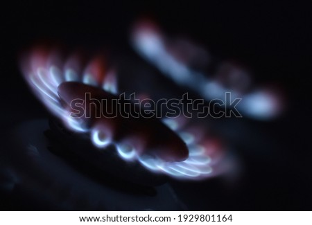  Natural gas burning a blue flames on black background