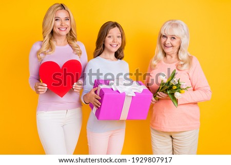 Photo of grey haired retired pensioner lady family generation picture hold gifts 8-march tulips heart isolated on yellow color background