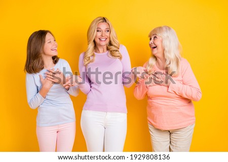 Photo of happy funky women little girl old young lady good mood joke family picture isolated on yellow color background