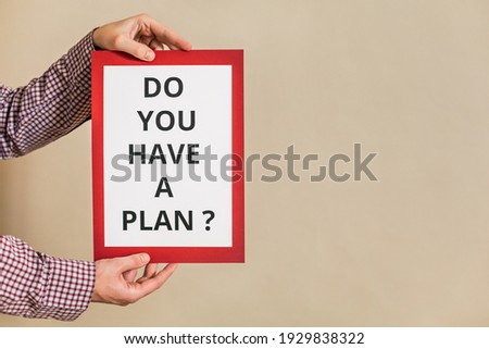 Image of man holding paper with text do you have a plan.