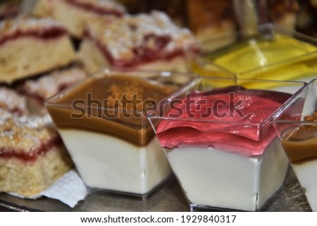 jelly dessert in plastic cups on the table with sweets. High quality photo